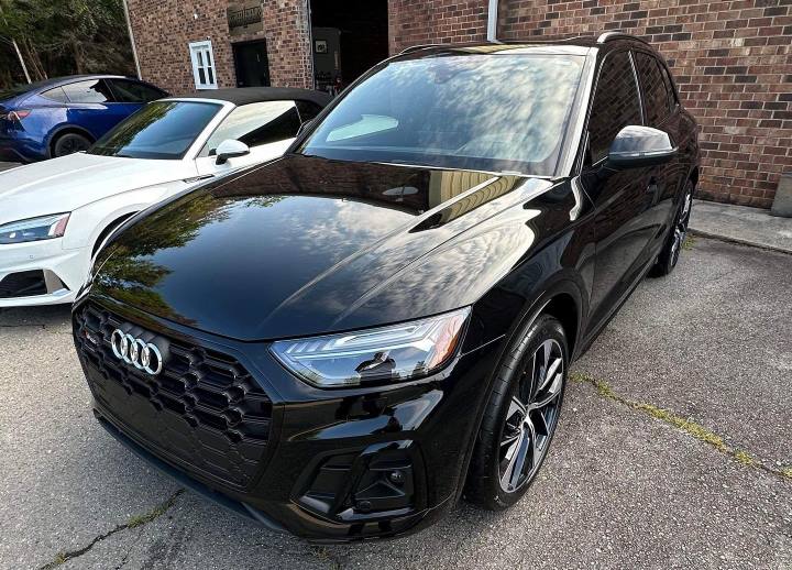 An Audi with black paint and a recent ceramic coating, featuring a deep, glossy shine